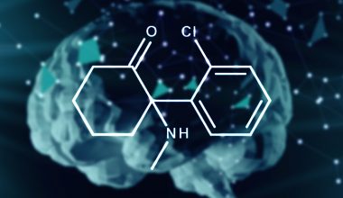 Ketamine moleculeon blurred brain background