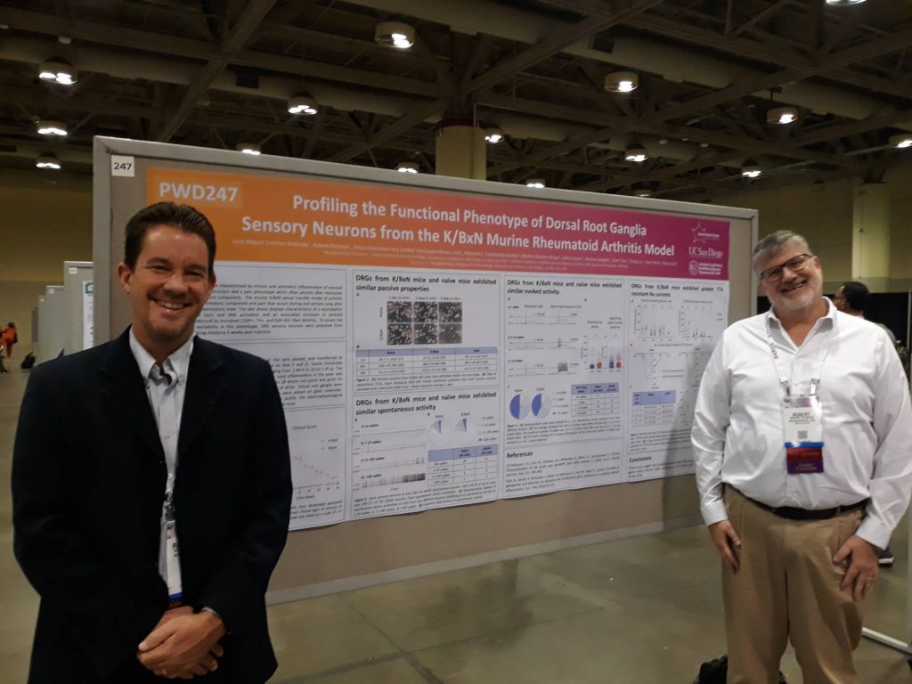 Raymond Price and Bob Petroski in front of poster at IASP 2022