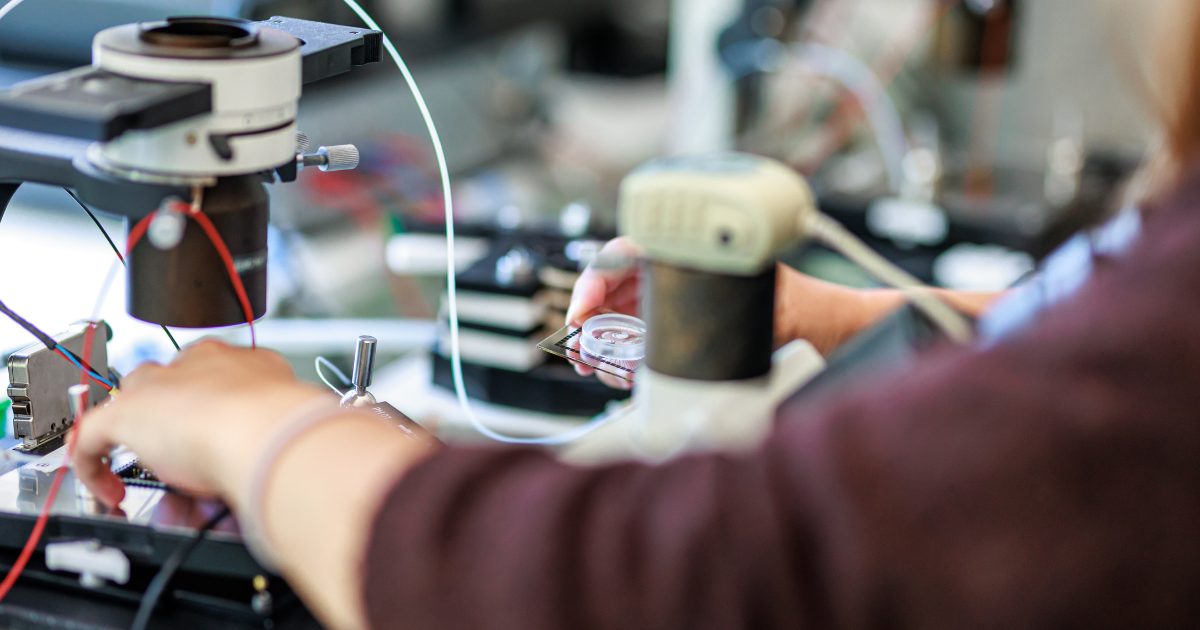 Scientist in lab with patch clamp machine
